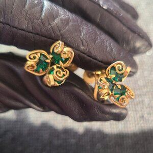 Vintage gold tone shamrock or clover featuring emerald green rhinestones.